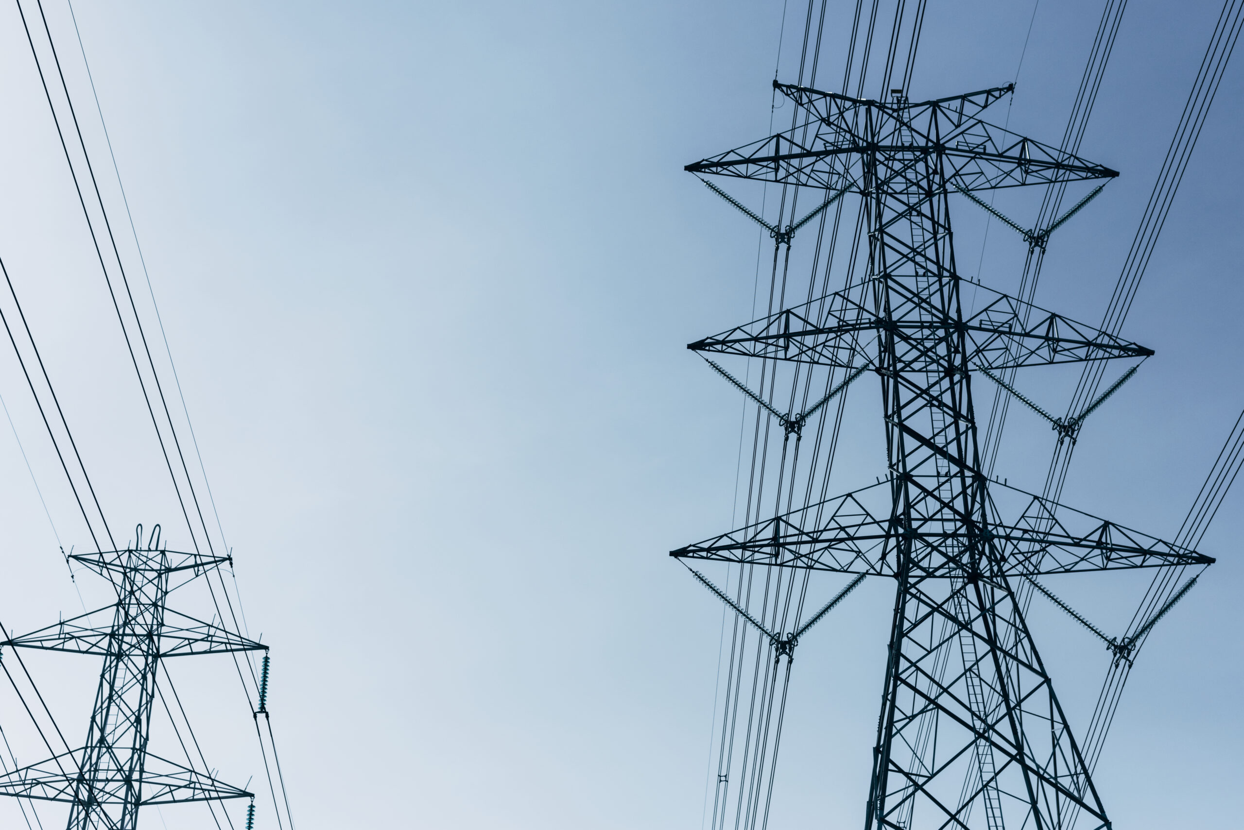 High voltage power lines in the blue sky